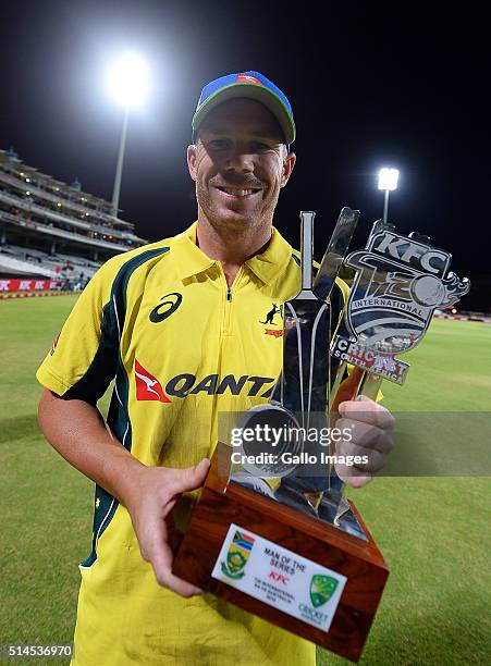 David Warner of Australia holds the man of the series trophy after winningthe 3rd KFC T20 International match between South Africa and Australia at...