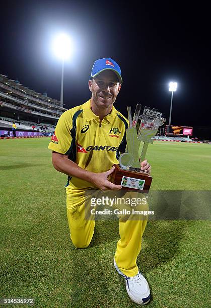 David Warner of Australia holds the man of the series trophy after winningthe 3rd KFC T20 International match between South Africa and Australia at...