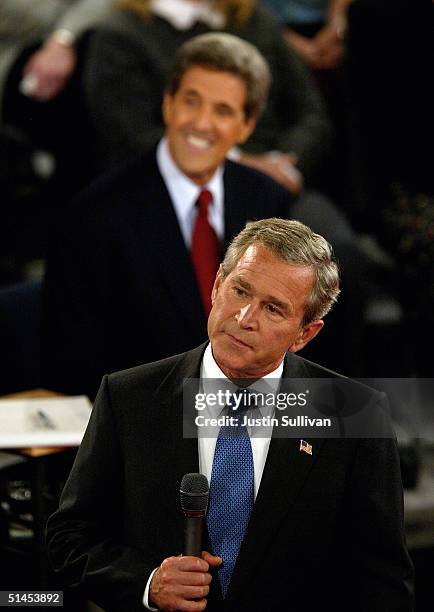 Democratic presidential nominee John Kerry looks on as President George W. Bush pauses during the presidential debate at Washington University...