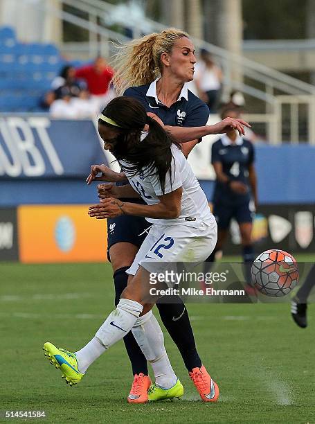 Alex Scott of England collides with Kheira Hamraoui of France during a match against in the 2016 SheBelieves Cup at FAU Stadium on March 9, 2016 in...