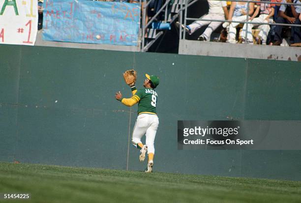 Outfielder Reggie Jackson of the Oakland Athletics rushes to catch the ball during the World Series against New York Mets at Oakland-Alameda County...