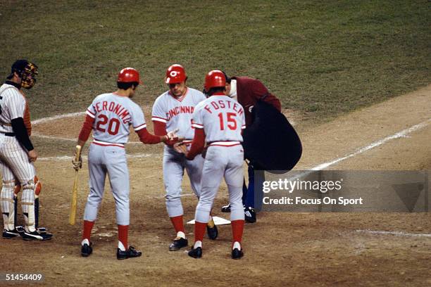 Johnny Bench of the Cincinnati Reds is congratulated by his teammates Cesar Geronimo and George Foster during the World Series against the New York...