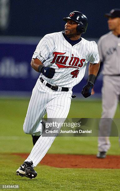 Torii Hunter of the Minnesota Twins rounds second base just before he was thrown out by left fielder Hideki Matsui of the New York Yankees while...