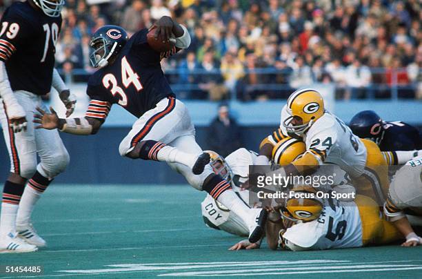 Walter Payton of the Chicago Bears is tackled by the Green Bay Packers.