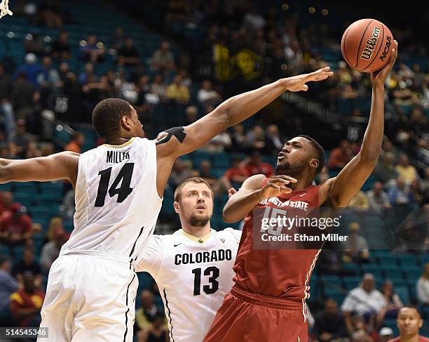 Junior Longrus of the Washington State Cougars shoots against Tory Miller of the Colorado Buffaloes during a first-round game of the Pac-12...