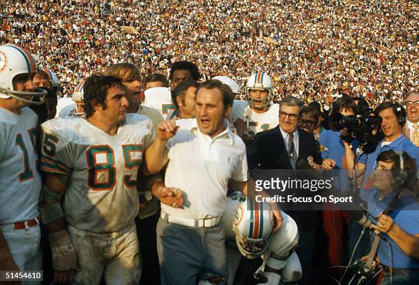 Don Shula, coach of the Miami Dolphins, talks to reporters while surrounded by his team on the field during the Super Bowl VIII against the...