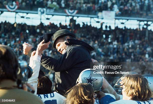 Tom Landry, head coach of the Dallas Cowboys, is carried off the field by his team after winning Super Bowl VI against the Miami Dolphins at Tulane...