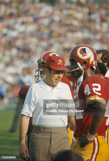 George Allen, coach of the Washington Redskins talks to Charley Taylor during Super Bowl VII against the Miami Dolphins at Memorial Coliseum in Los...