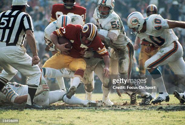 Billy Kilmer quarterback for the Washington Redskins gets gang tackled by the Miami Dolphins during Super Bowl VII at Memorial Coliseum on October...