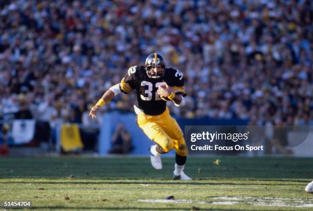 Franco Harris running back for the Pittsburgh Steelers runs with the ball during Super Bowl XIV against the Los Angeles Rams at the Rose Bowl on...