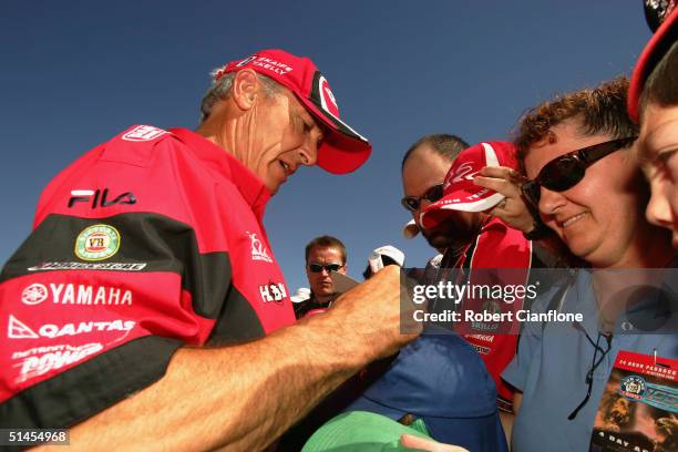 Peter Brock of the Holden Racing Team signs autographs for fans as he prepares for the Bathurst 1000, which is round ten of the 2004 V8 Supercar...