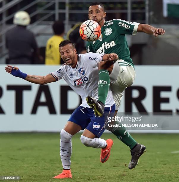 Vitor Hugo of Brazils Palmeiras, vies for the ball with Nicolas Lopez of Uruguay's Nacional, during their 2016 Copa Libertadores football match held...