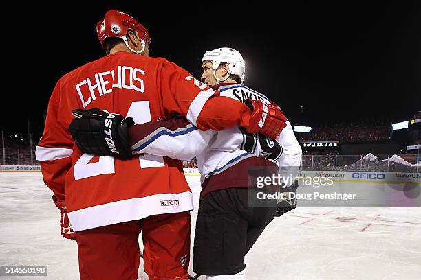 Chris Chelios of the Detroit Red Wings and Joe Sakic of the Colorado Avalanche skate across the ice during the 2016 Coors Light Stadium Series Alumni...