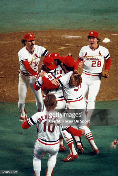 Bruce Sutter, Darrell Porter, and Keith Hernandez of the St. Louis Cardinals greet teammates on the mound to celebrate winning the World Series...