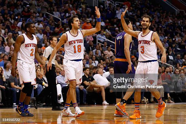 Sasha Vujacic of the New York Knicks high-fives Jose Calderon after scoring against the Phoenix Suns during the first half of the NBA game at Talking...