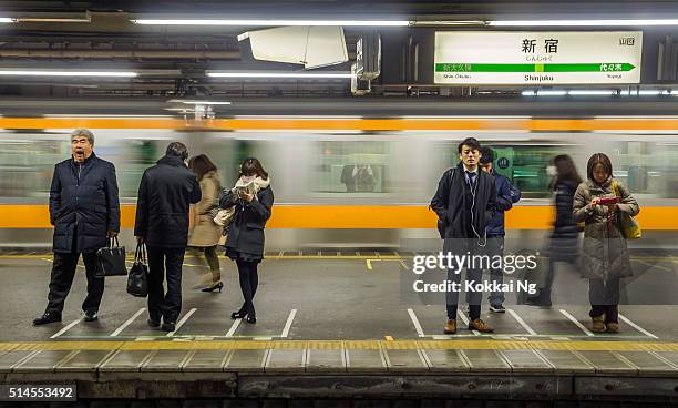 commuters waiting at shinjuku station - kanto region stock pictures, royalty-free photos & images