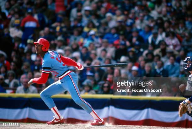 Willie McGee of the St. Louis Cardinals connects with the ball and runs for first during the World Series against the Milwaukee Brewers at County...