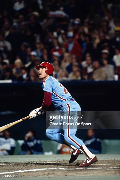 Mike Schmidt of the Philadelphia Phillies watches the flight of his home run against the Kansas City Royals during the World Series at Royals Stadium...
