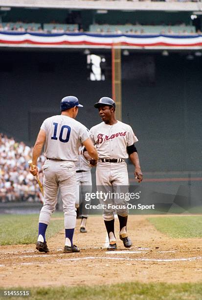 Ron Santo of the Chicago Cubs congratulates Hank Aaron of the Atlanta Braves during the All-Star Game at RFK Stadium on July 23, 1969 in Washington,...