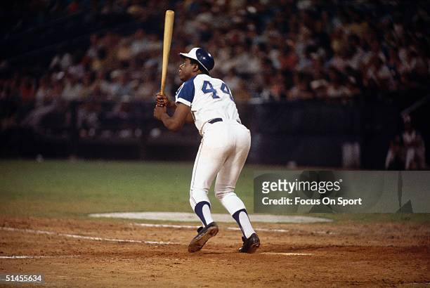 Outfielder Hank Aaron of the Atlanta Braves watchs the flight of the ball at Atlanta-Fulton County Stadium during the 1970s in Atlanta, Georgia.