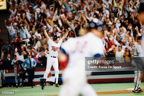 Gene Larkin of the Minnesota Twins celebrates after driving in the game winning run against the Atlanta Braves in Game seven of the 1991 World Series...