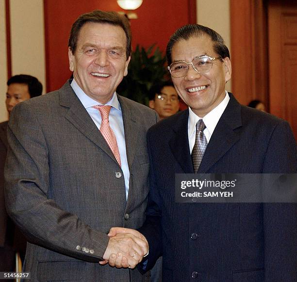 German Chancellor Gerhard Schroeder is greeted by Nong Duc Manh , Communist Party General Secretary at the party's headquarter in Hanoi, 09 October...