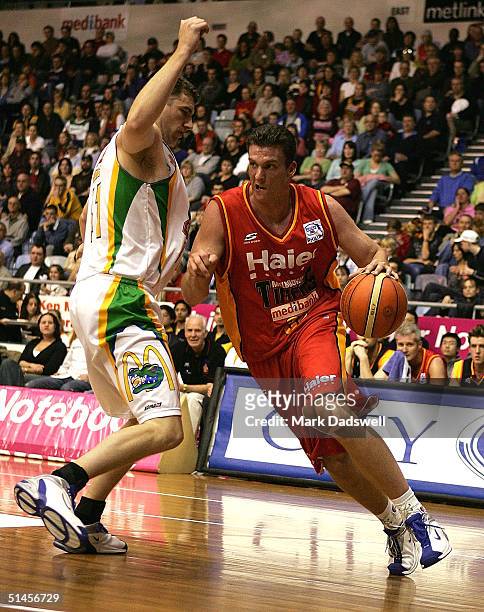 Stephen Hoare for the Tigers works his way around John Rillie for the Crocs during the NBL round 2 game between the Melbourne Tigers and the...