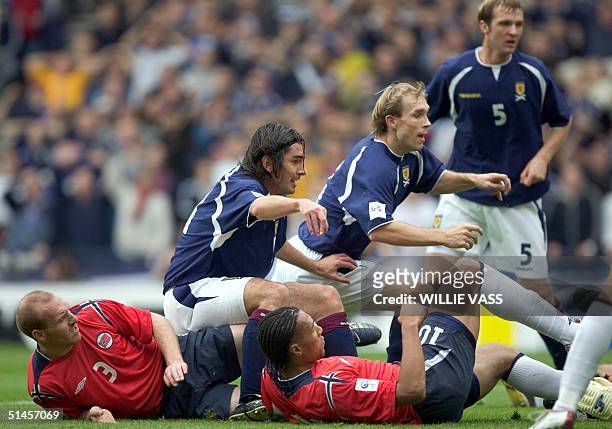 Scotland's Richard Hughes and Russell Anderson stab the ball at the Norwegian goal, 09 October 2004 during their Football World Cup 2006 qualifier...