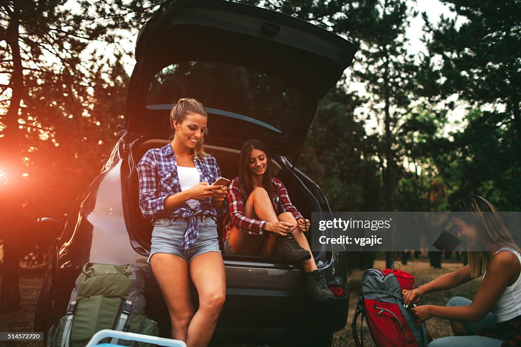 Young Women Preparing For Hike and Camping In Forest.