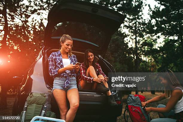 young women preparing for hike and camping in forest. - camping friends stock pictures, royalty-free photos & images