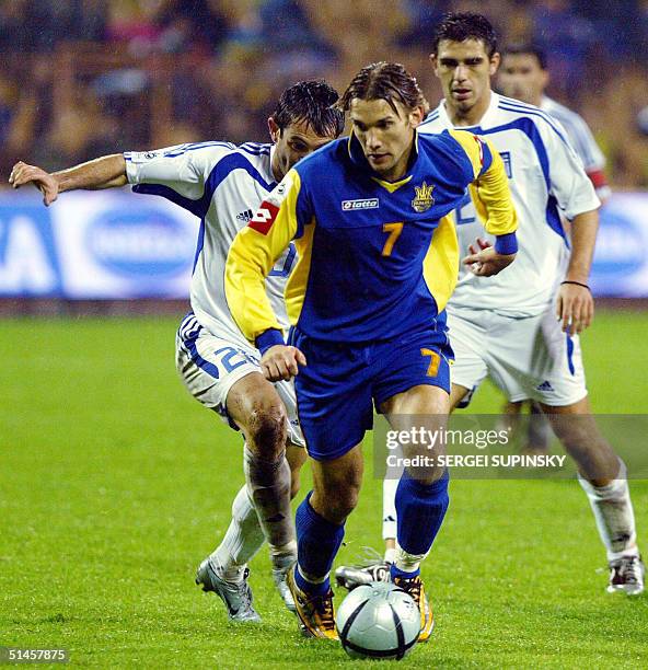 Giorgios Karagounis and Kostas Katsouranis , players of the National team of Greece, vie for the ball against Andriy Shevchenko , player of the...