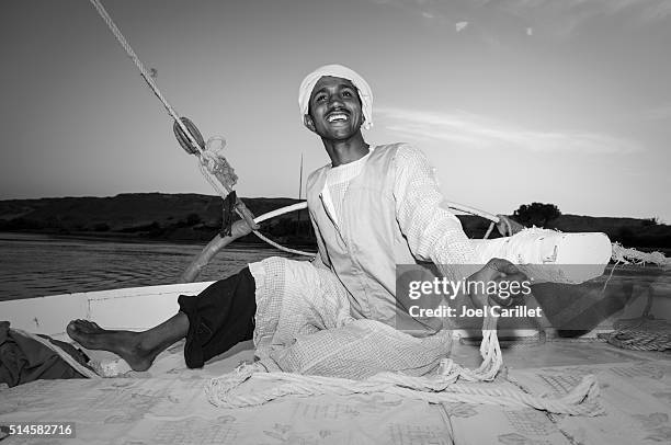 egyptian man sailing a felucca on nile river - upper egypt stock pictures, royalty-free photos & images