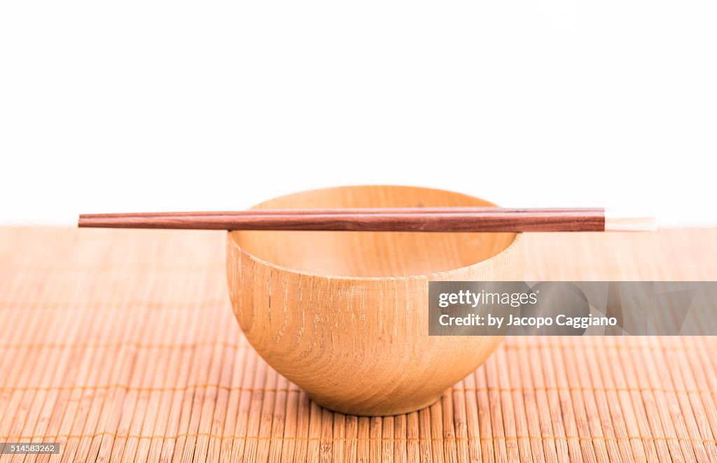 Asian wooden rice bowl with sticks