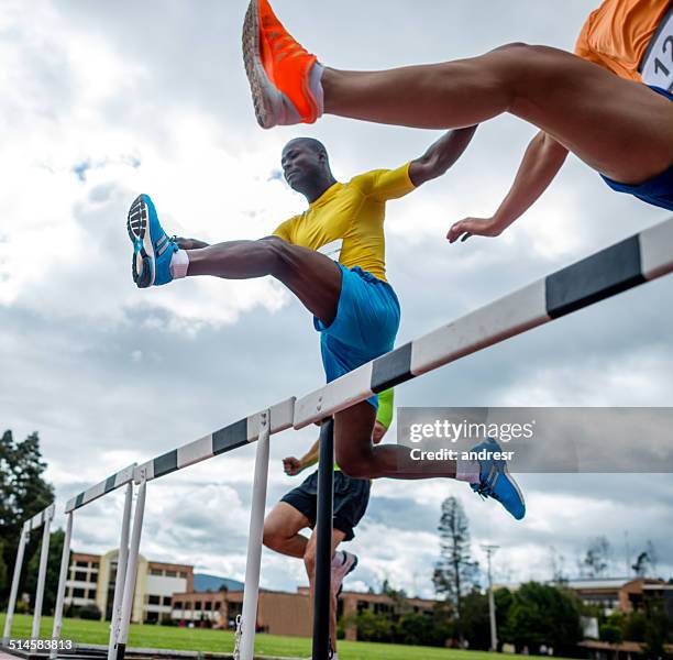 men hurdling - athlete stock pictures, royalty-free photos & images