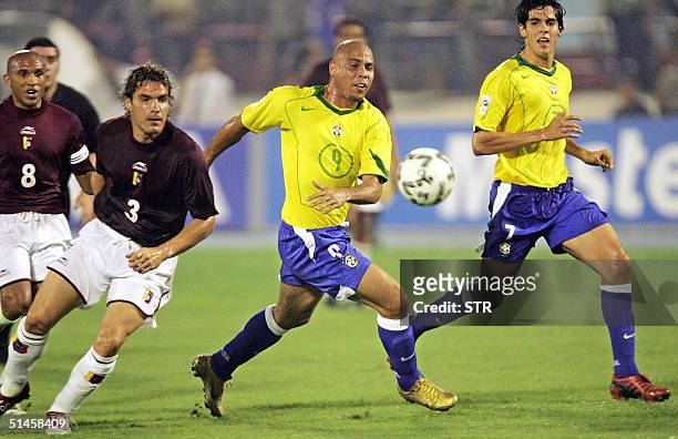 Brazilian Ronaldo Nazario and Kaka elude Venezuelan Jose Manuel and Luiz Pajaro 09 October 2004 during their FIFA World Cup Germany 2006 qualifying...