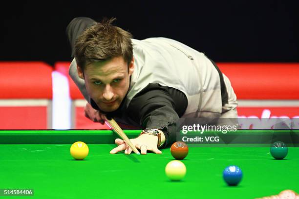 David Gilbert of England plays a shot in the first round match against Stuart Bingham of England during the Ladbrokes World Grand Prix at Venue Cymru...
