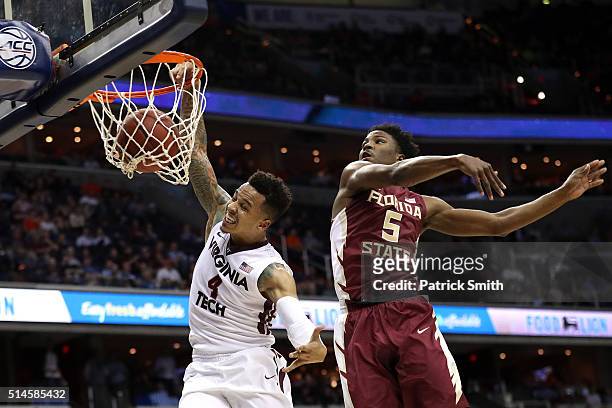 Seth Allen of the Virginia Tech Hokies dunks in front of Malik Beasley of the Florida State Seminoles during the first half in the second round of...