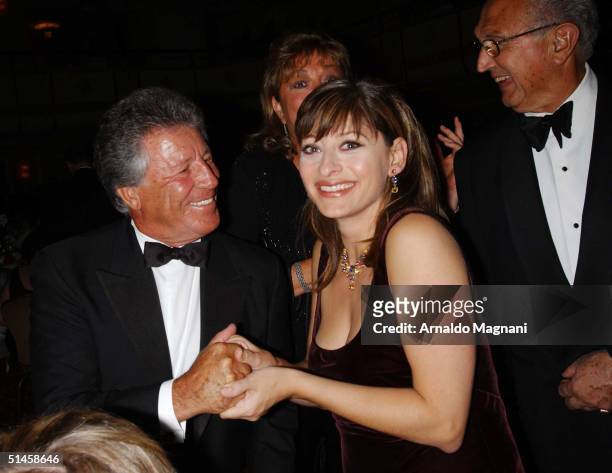 Mario Andretti and CNBC anchor woman Maria Bartiromo attend a pre-dinner Gala for the Columbus Day Parade October 9, 2004 in New York City.