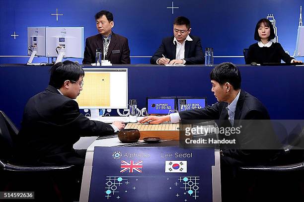 In this handout image provided by Google, South Korean professional Go player Lee Se-Dol puts his first stone against Google's artificial...