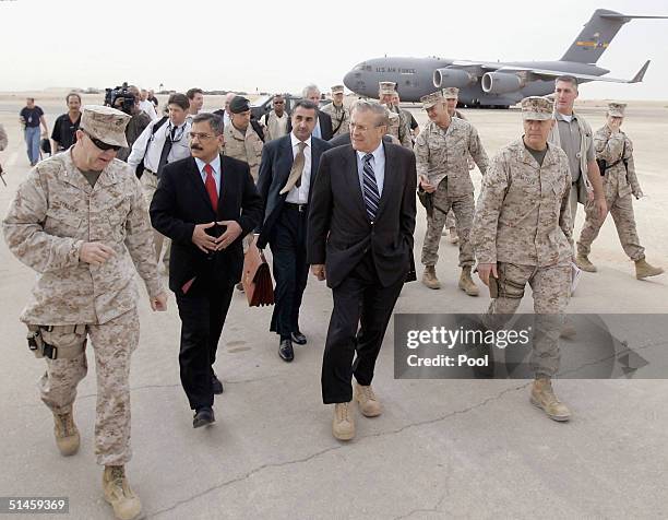 Maj. Gen Keith Stalder, left, gives Secretary of Defense Donald Rumsfeld and Iraqi Minister of Defense Hazim al Sha'laan, red tie, a tour of the Al...