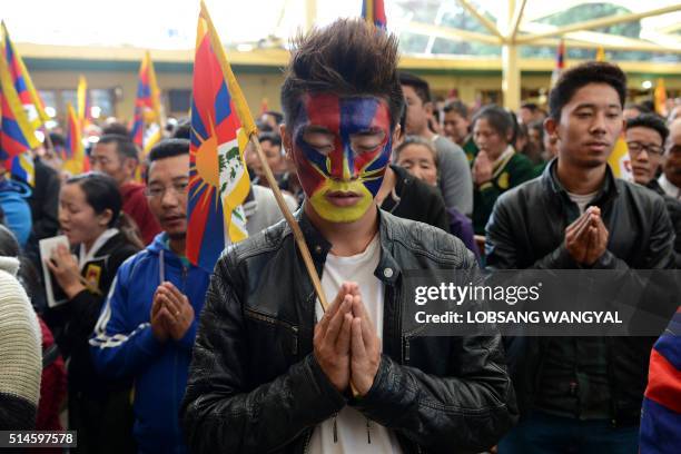 Tibetan exiles pray as they mark the 57th anniversary of the 1959 uprising against Chinese rule in McLeod Ganj on March 10, 2016. - Beijing says its...