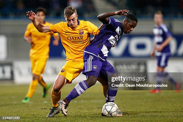 Orel Mangala of Anderlecht battles for the ball with Oriol Busquets Mas of Barcelona during the UEFA Youth League Quarter-final match between...