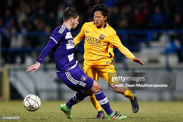 Samy Bourard of Anderlecht battles for the ball with Seungwoo Lee of Barcelona during the UEFA Youth League Quarter-final match between Anderlecht...