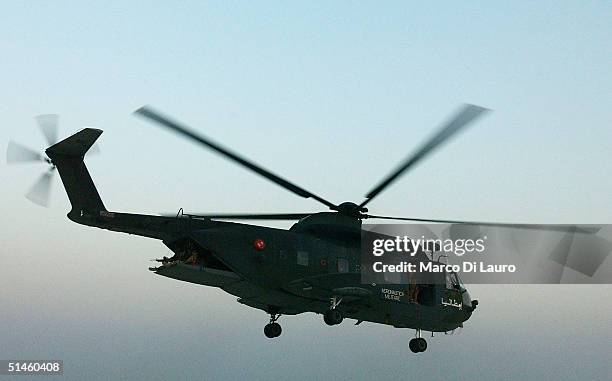 An Italian Air Force HH-3F helicopter from the Italian Joint Task Force flies near the Italian base Camp Mittica on October 10, 2004 in Nasiriyah in...