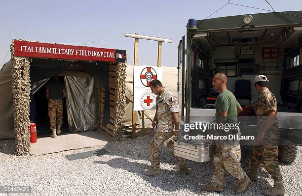 Italian Army soldiers from the Italian Joint Task Force Iraq, Brigata Friuli, arrive with food for the patients at the Italian Army field hospital at...