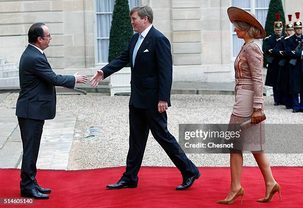 French President Francois Hollande welcomes Queen Maxima of the Netherlands and King Willem-Alexander of the Netherlands prior to attend a meeting at...