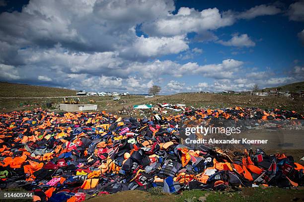 Hundreds of used life vests lie on a makeshift rubbish dump hidden in the hills above the town on March 10, 2016 in Mithymna, Greece. Local...