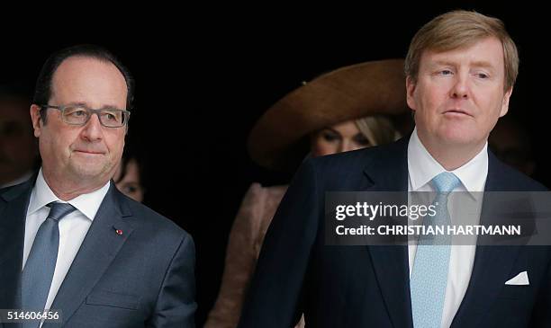 French President Francois Hollande , King Willem Alexander of the Netherlands arrive to sign the visitors' book at the Louvre Museum on March 10,...