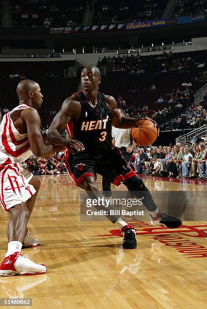 Dwyane Wade of the Miami Heat drives to the basket while being defended by Charlie Ward of the Houston Rockets on October 10, 2004 at the Toyota...