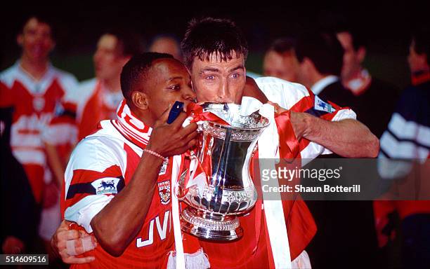 Arsenal goalscorers Ian Wright and defender Andy Linighan celebrate with the trophy after the 1993 FA Cup Final replay between Arsenal and Sheffield...